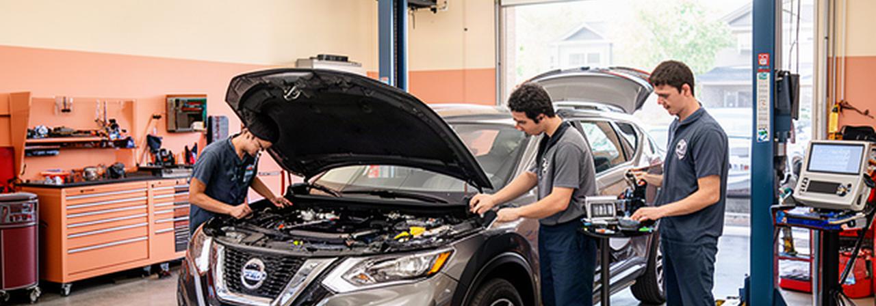 Certified technicians inspecting a vehicle inside a clean automotive repair shop in Vaughan