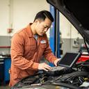 Lead mechanic Marcus Chen examining a European vehicle in a Vaughan repair bay